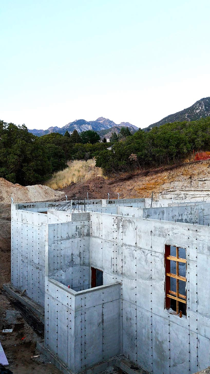 Concrete foundation contractors completing tall foundation walls for a custom home build in the Pepperwood Community in Sandy Utah