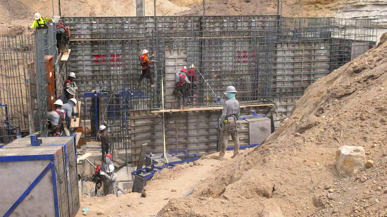 Construction crew pouring concrete for a stacked-panel 20-foot foundation wall by Utah concrete contractor in Sandy