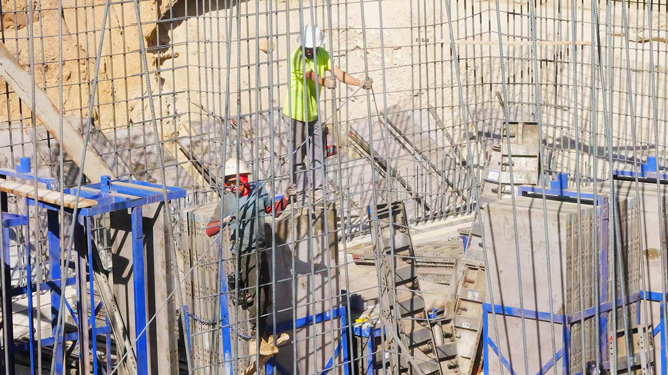 Concrete foundation contractors tying rebar and setting aluminum forms for a custom foundation in the Pepperwood Community in Sandy Utah